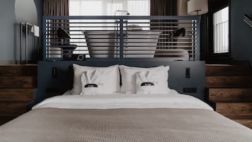 Moderni hotellihuone, jossa on sänky, sisäänrakennettu työpöytä ja suuri ikkuna.