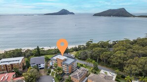 A coastal residential area with a prominent orange location marker. - Albacore 7, 12 Ondine Close, Waterfront Unit with (Nelson Bay)