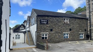 A stone building with a sign reading "Station Lodge." - Station Lodge (Windermere)
