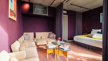 Suite Cinéma | Living area | 200-cm TV with cable channels, tablet, Netflix