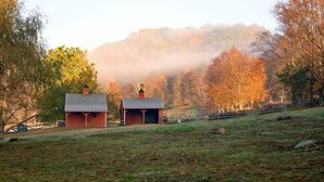 A rural landscape with two barns and a misty forest in the background. - Club Getaway Mountain View 3 (Kent)