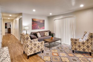A living room with a sofa, two armchairs, a coffee table, and a patterned rug. - 6B Cozy Moab Redcliff Condo, Pet Friendly, Pool & Hot Tub (Moab)