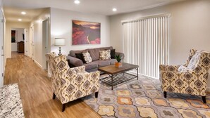 A living room with a sofa, two armchairs, a coffee table, and a patterned rug. - 6B Cozy Moab Redcliff Condo, Pet Friendly, Pool & Hot Tub (Moab)