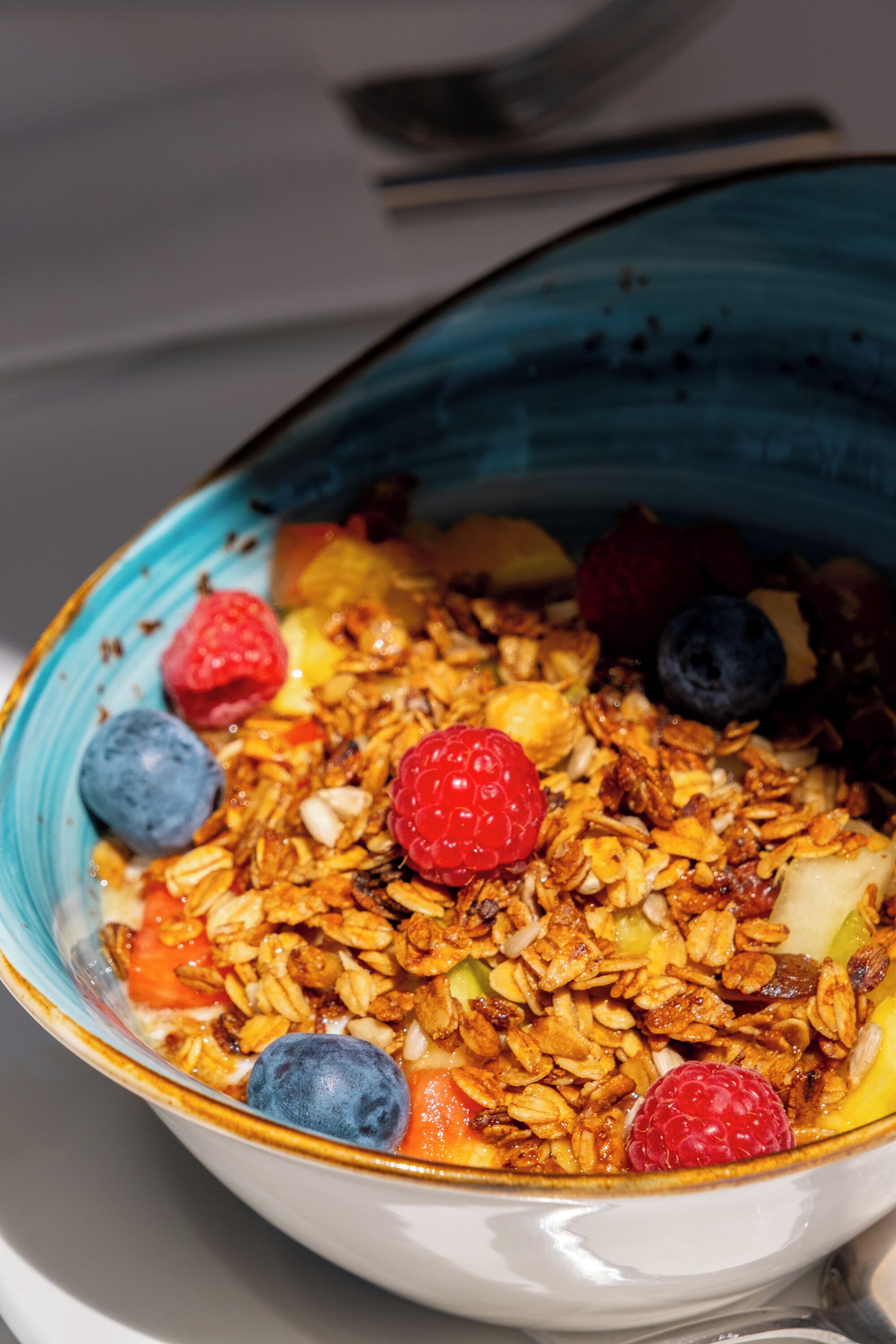 A bowl of granola with fruits and nuts.