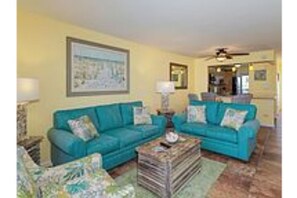 Relax in this inviting living room with a sofa, armchair, and coffee table.