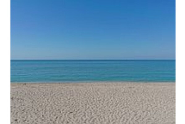 Walking along the wide, sandy beach is a serene experience.