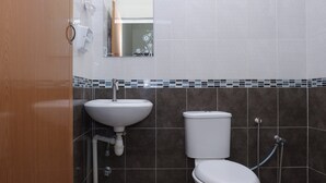 A bathroom with a white sink, a toilet, and a shower. - Hotel O Kay Inn Kerteh (Kerteh)