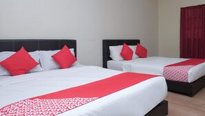 Two twin beds with red and white bedding, a red curtain, and a light fixture on the wall. - Hotel O Kay Inn Kerteh (Kerteh)