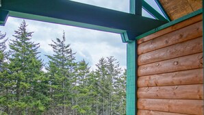 A wooden deck with two chairs and a view of a forest. - Camp 4 24: Slope Side, Cozy 2 BR with Shuttle Service (Snowshoe)