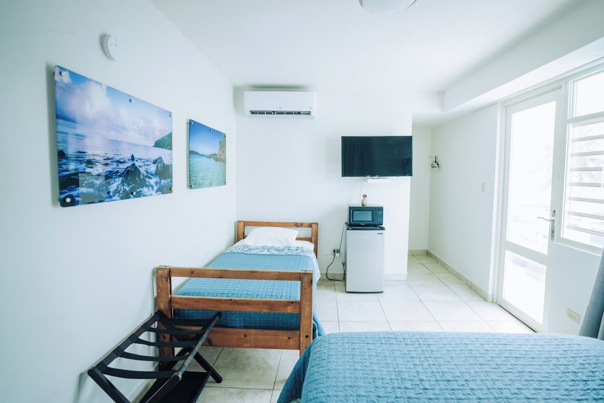 Deluxe Triple Room, Partial Ocean View | Minibar, free WiFi, bed sheets