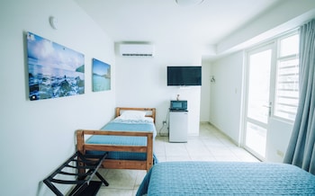 Deluxe Triple Room, Partial Ocean View | 1 bedroom, minibar, free WiFi, bed sheets at El Navegante de Culebra