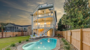 A multi-story house with a swimming pool, a wooden deck, and a fenced backyard. - CLOSE TO CHARLESTON/ROOFTOP/LUXURY AMENTIES/POOL/OCEAN VIEW/FANTASTIC FALL RATES (Isle of Palms)