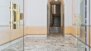 A marble-floored corridor with a staircase leading to a room. - Boutique Apartment in Via Roma by Wonderful Italy (Genova)