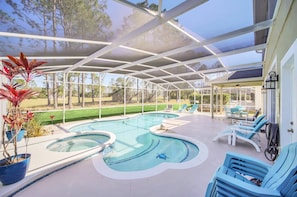 A covered outdoor swimming pool with lounge chairs and potted plants. - South-Facing Pool & Spa   • Golf Course View • Near Disney • Golf (Davenport)