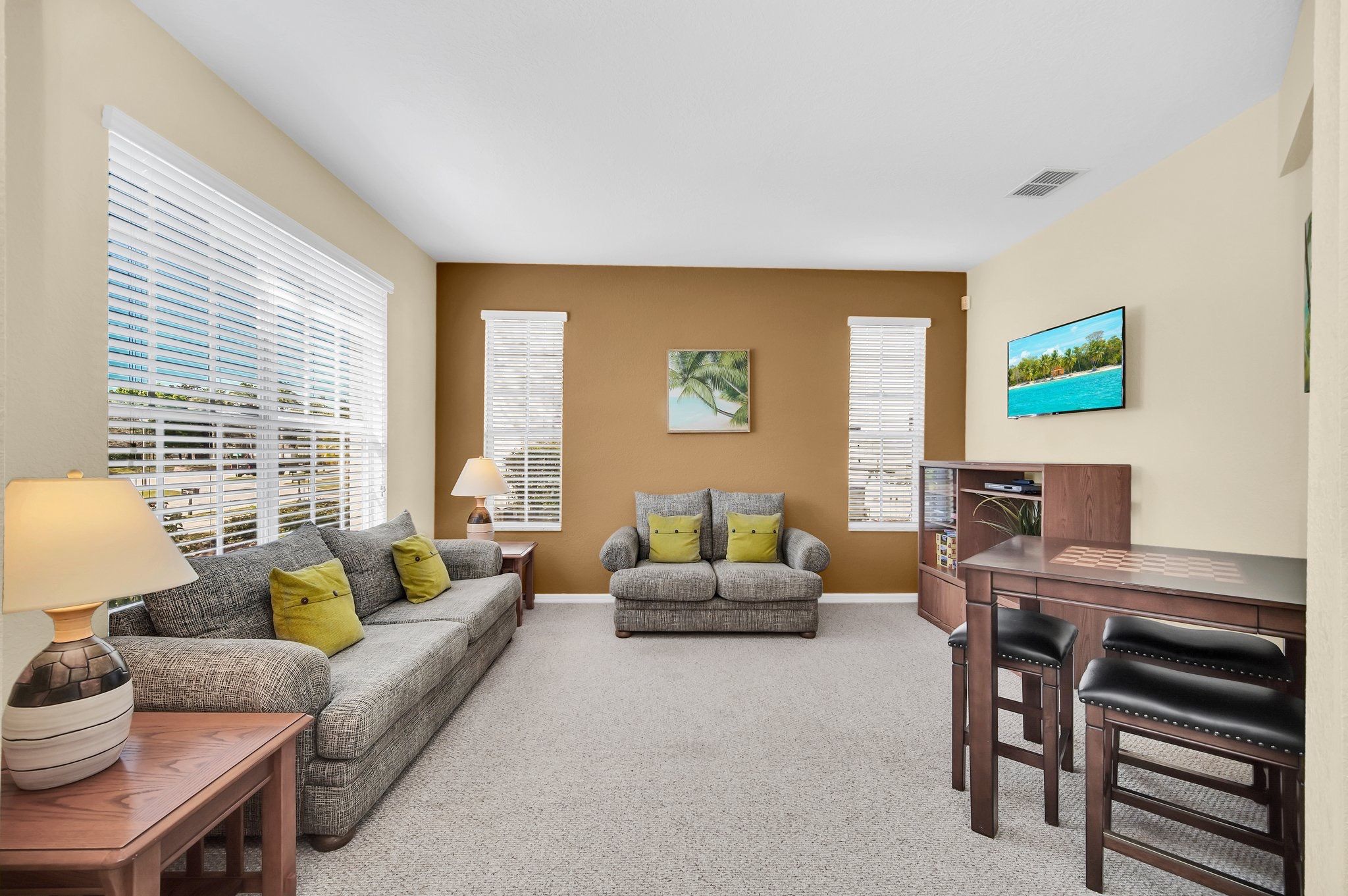 A living room with two sofas, a coffee table, a lamp, a TV, and a bookshelf.