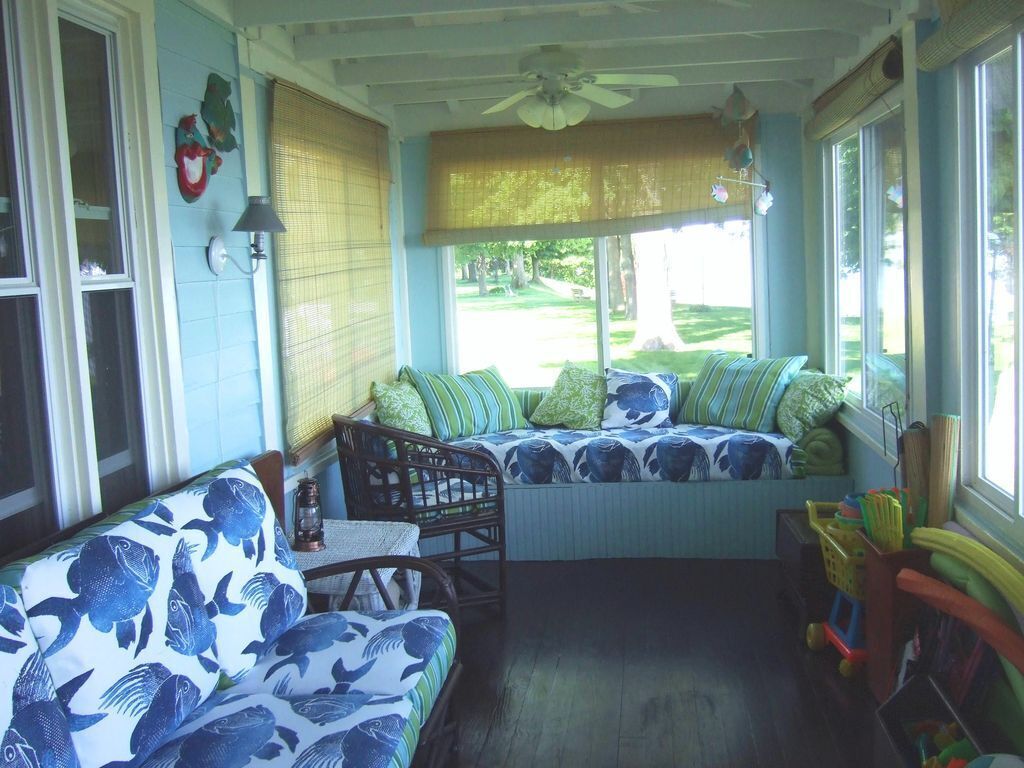 A cozy room with a window seat, a ceiling fan, and a view of the outdoors.