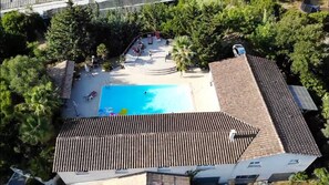 Relax on the rooftop terrace with a swimming pool surrounded by lush greenery and trees.