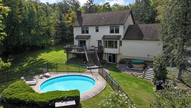 A two-story house with a swimming pool, a deck, and a hot tub. - Lakefront/Legoland/West Point Retreat Under 1 Hour From NYC! Heated pool & Spa! (Monroe)