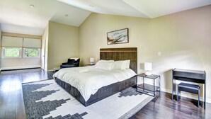 A spacious bedroom with a large bed, a desk, and a chair. - Lakefront/Legoland/West Point Retreat Under 1 Hour From NYC! Heated pool & Spa! (Monroe)