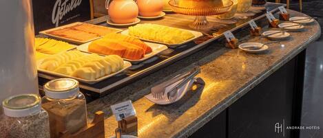 A buffet with various food items and condiments.