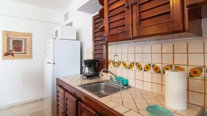 A kitchen with a sink, a coffee maker, and a refrigerator. - Private Terrace & Hammock Near Mamitas Beach (Playa del Carmen, Q.R.)