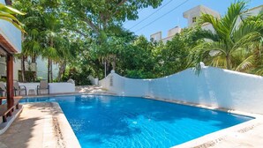 A swimming pool with a white wall and a tiled deck. - Private Terrace & Hammock Near Mamitas Beach (Playa del Carmen, Q.R.)