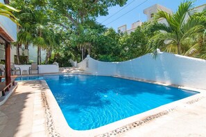 A swimming pool with a white wall and a tiled deck. - Private Terrace & Hammock Near Mamitas Beach (Playa del Carmen, Q.R.)