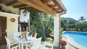 A patio with a pool, white furniture, and a pergola. - VILLA MATEU - 5 MIN WALK TO THE OLD TOWN (Pollensa)