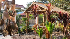 A garden with a wooden pergola, various plants, and a fence. - NELLY HOUSE (AP. SANDIA) (SAMARA)