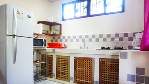 A compact kitchen with a refrigerator, microwave, and sink. - NELLY HOUSE (AP. SANDIA) (SAMARA)