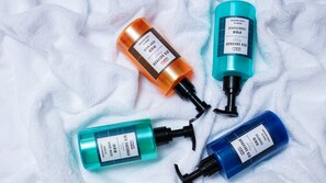 Four bottles of Ben Sherman body wash on a white towel. - Holiday Inn Express Hengyang High-Tech Zone by IHG (Hengyang)