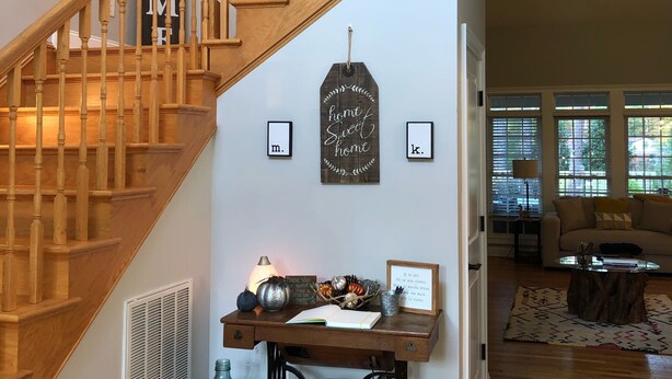 A staircase with wooden railings and a sign that reads "WELCOME". - The Mulligan House in the heart of Pinehurst, NC. (Pinehurst)