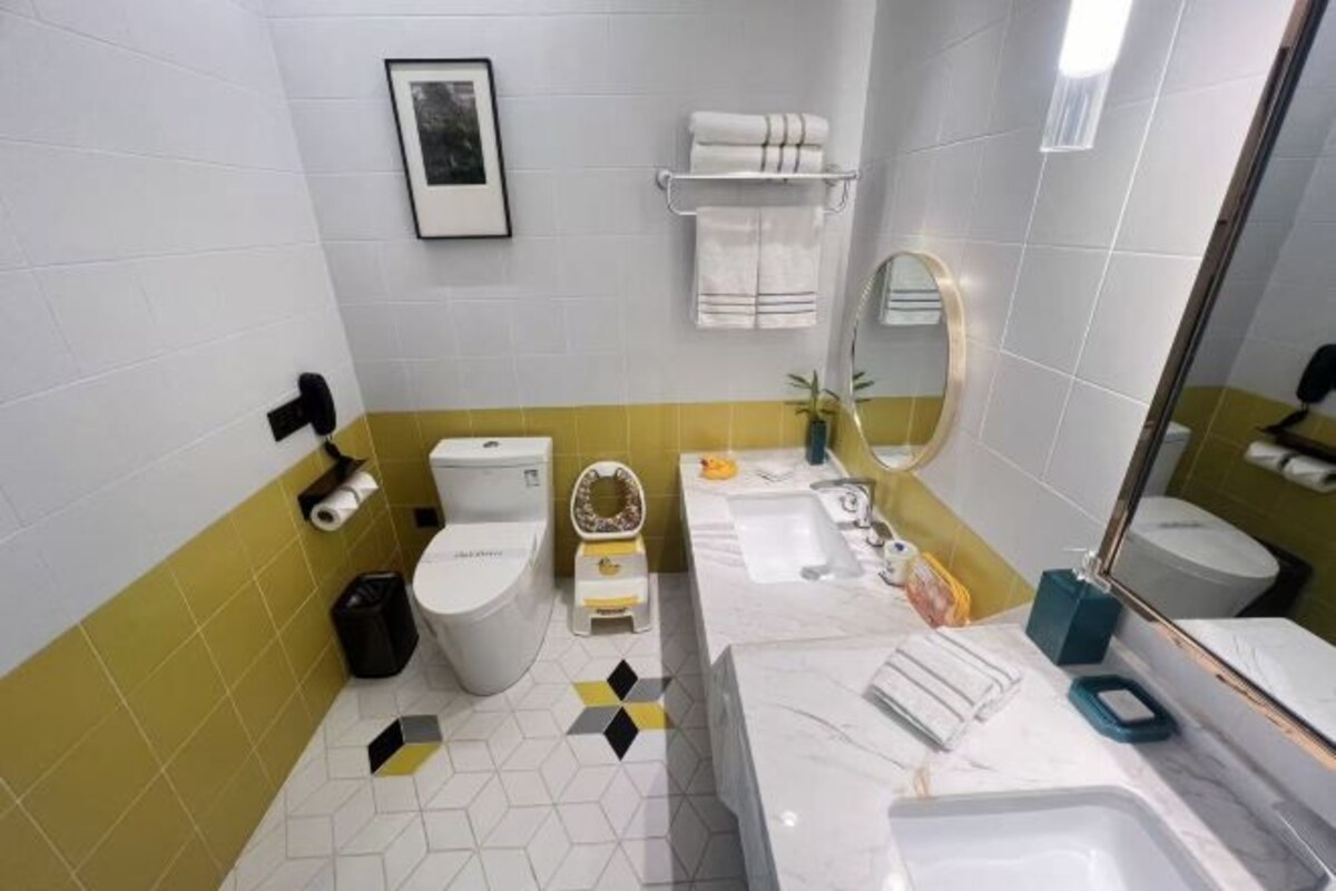 Un baño con inodoro, lavamanos y espejo.