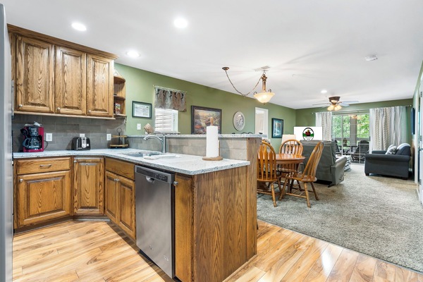 The Open Floor Plan includes a fully equipped Kitchen, Dining Area, Sunroom, Living Space, and  3 Bedrooms with Private Baths