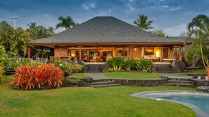 A house with a covered porch, a swimming pool, and tropical landscaping. - Ultra private oceanfront gated compound with pool & spa just minutes from town. (Kailua-Kona)