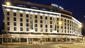 A modern hotel with a prominent "HOTEL NEIVA" sign, featuring a symmetrical facade with evenly spaced windows and a central entrance. - Nelva (Murcia)