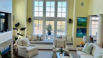 TV connectée, cheminée, livres, écrans d'ordinateur