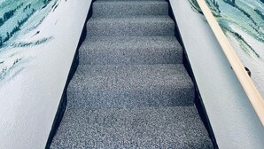 A staircase with a 'Welcome Lakes Brain Village' sign at the top.