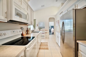 Enjoy cooking in this well-equipped kitchen with a stovetop, oven, and refrigerator.