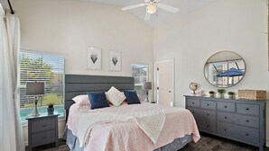 A bedroom with a bed, nightstands, a dresser, a ceiling fan, and a window with blinds. - *Disney Pool Home-Heated Pool Included-Clermont FL (Clermont)