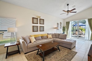 Relax in this inviting living room with a comfortable sofa, coffee table, and ceiling fan.