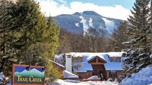 A snow-covered building with a sign reading "Trail Creek". - Trail Creek 54 (Killington)