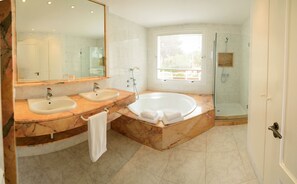 Bathtub, hair dryer, towels, toilet paper