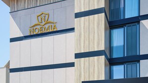 A modern building with a logo and name "NOEMIA" on the facade. - Boutique hotel Noemia (Baska Voda)