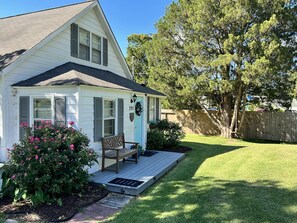 A single-story house with a front porch, a mailbox, and a number 291 sign. - Relax at this beautiful Historic Intracoastal Waterlily Cottage + Game Room (Coinjock)