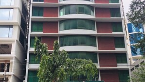 A multi-story hotel with a modern facade, featuring large windows and a prominent entrance. - Hotel Zakaria International (Dhaka)