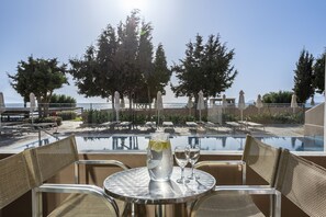 Relax by the tranquil pool, surrounded by tall trees and comfortable lounge chairs.