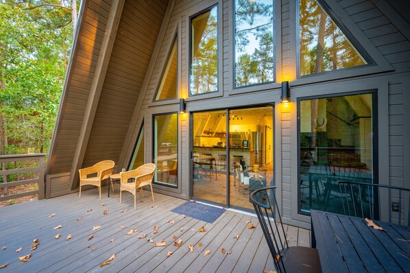 Relax on the deck with forest views from the large windows of this cabin.