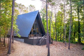 Escape to a secluded forest retreat with a cabin nestled among tall trees.