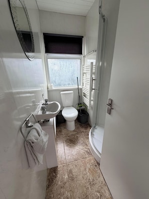 A bathroom with a toilet, sink, and shower. - Chalet 91A South Shore Bridlington, Sleeps 4 (Bridlington)